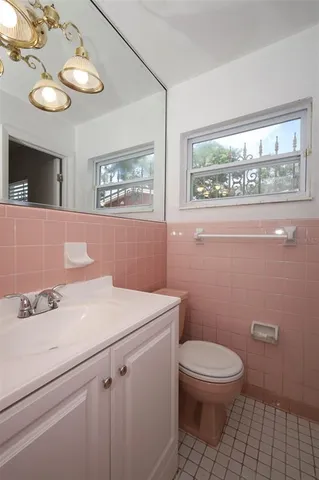 a bathroom with a sink a toilet and a mirror