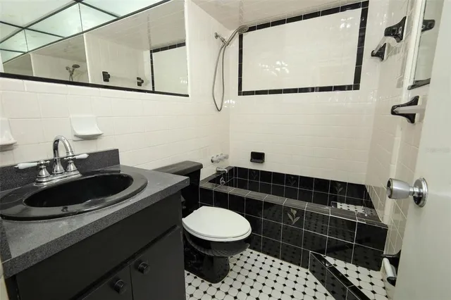 a bathroom with a sink a toilet and a mirror