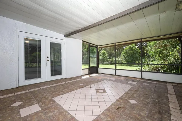 a view of backyard with large windows and stairs