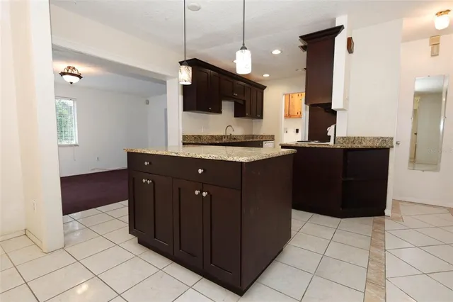a kitchen with a sink a counter top space and cabinets