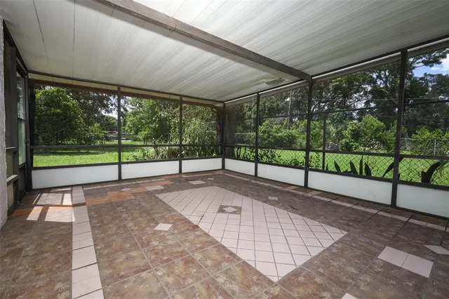 a view of yard with porch and wooden floor