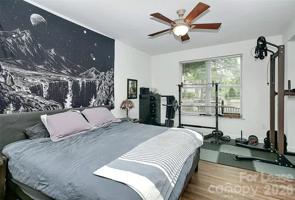 a bedroom with a large bed and a chandelier