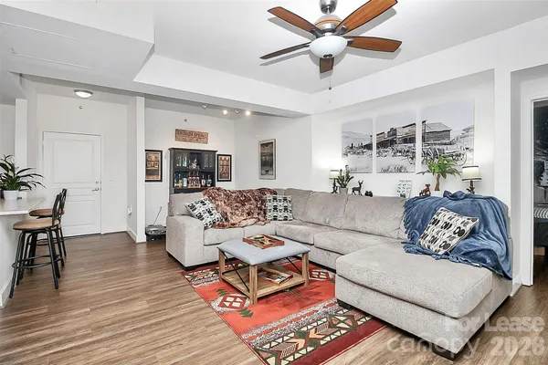 a living room with furniture and a wooden floor