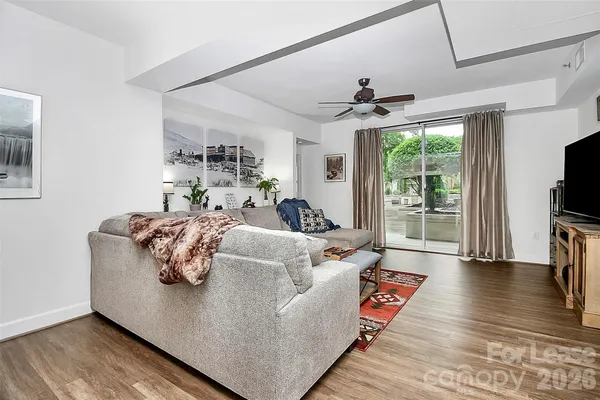 a living room with furniture fireplace and flat screen tv