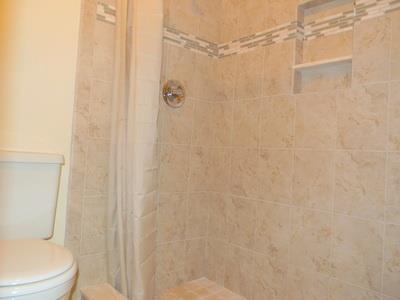 1683 Northwest Spruce Ridge Drive Stuart, FL 34994 - Photo 13 of 23 a white toilet sitting next to a shower curtain