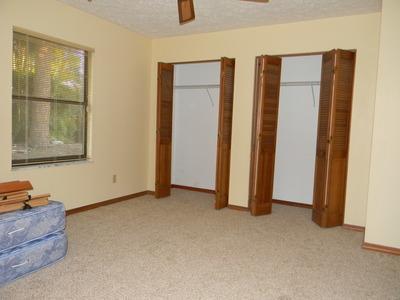 1683 Northwest Spruce Ridge Drive Stuart, FL 34994 - Photo 22 of 23 an empty room with windows and closet