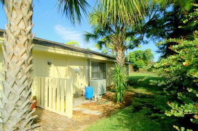 1683 Northwest Spruce Ridge Drive Stuart, FL 34994 - Photo 3 of 23 a view of a house with a yard