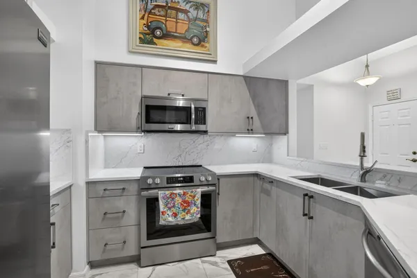 a kitchen with stainless steel appliances a stove sink and cabinets