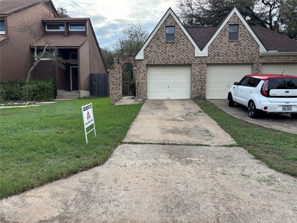a front view of a house with a garden and plants
