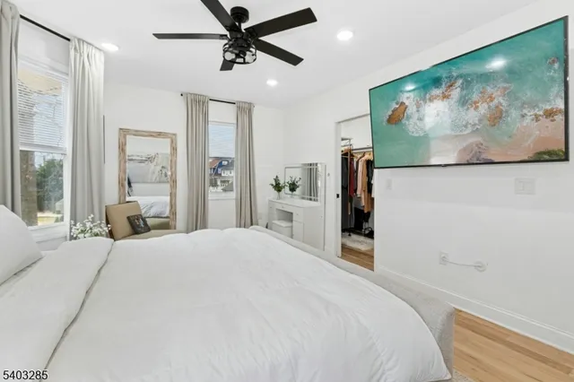 a bedroom with a large bed and a painting on the wall