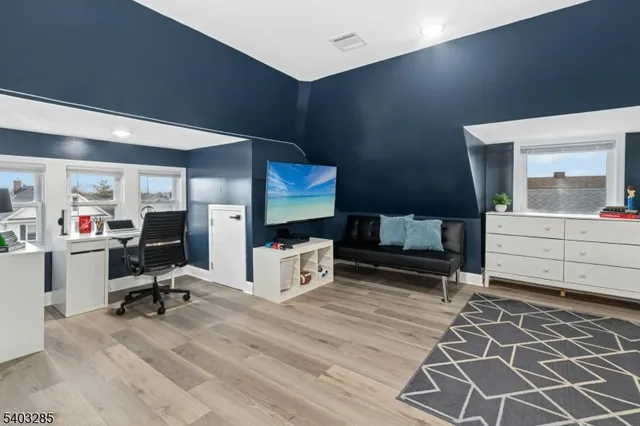 a view of workspace with wooden floor and windows
