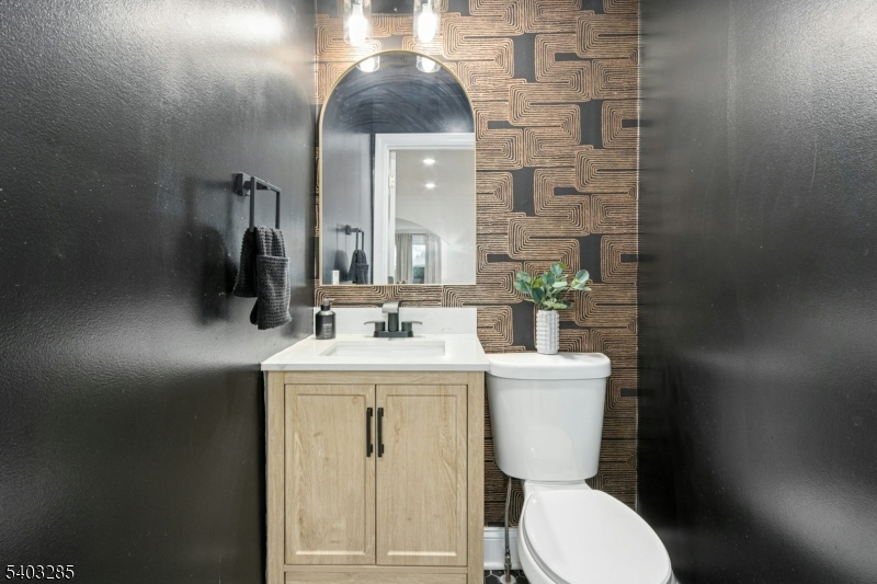 721 Summit Street Linden, NJ 07036 - Photo 9 of 27 a bathroom with a toilet a sink and mirror