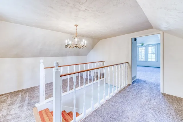 a view of an empty room with chandelier