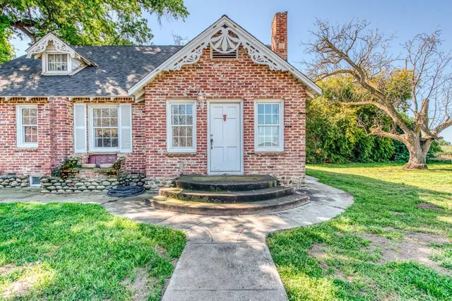 an empty room with wooden floor and window