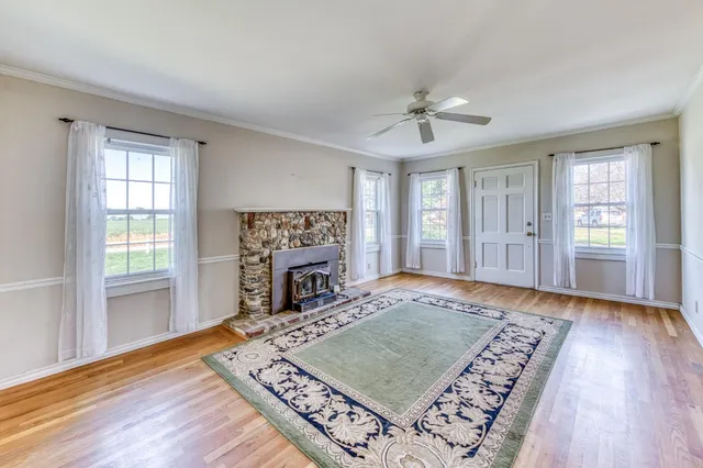 a view of a room with wooden floor and windows