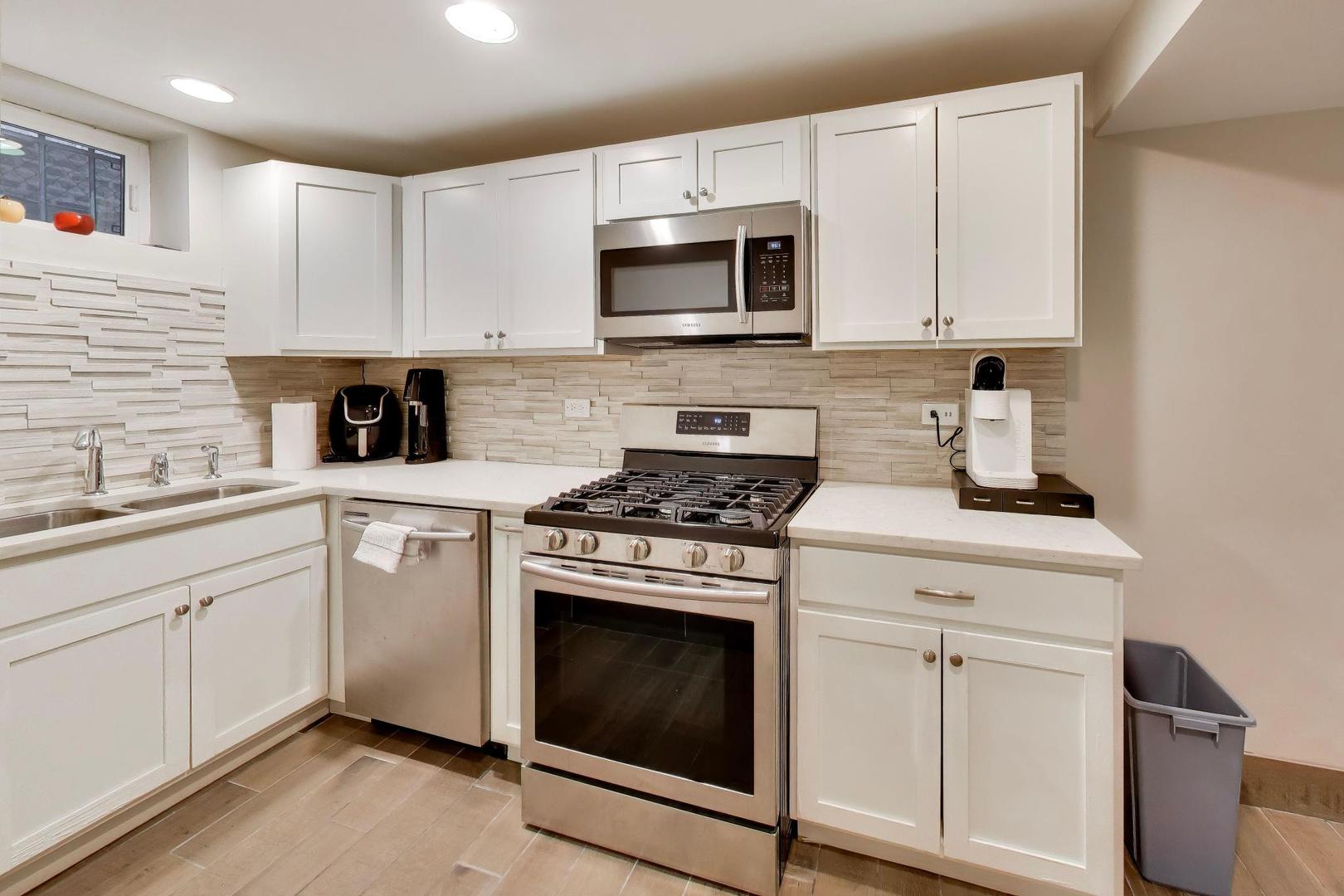 7015 North Sheridan Road Chicago, IL 60626 - Photo 25 of 40 a kitchen with cabinets stainless steel appliances and sink
