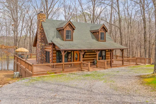 a view of a house with a yard and fence