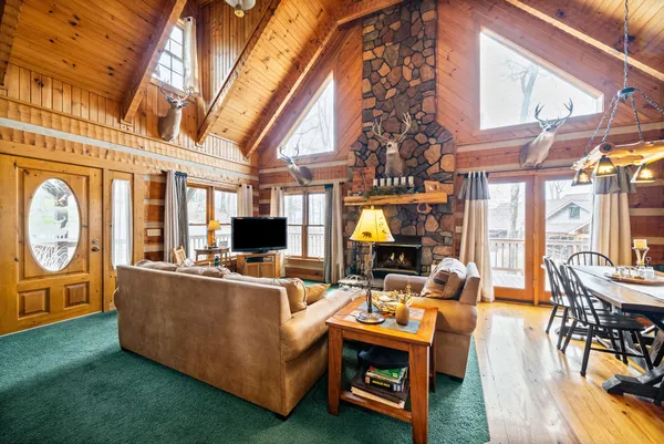 a living room with fireplace furniture and a large window