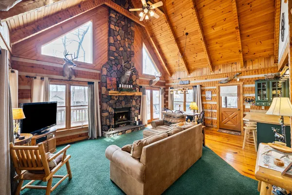 a living room with fireplace furniture and a flat screen tv