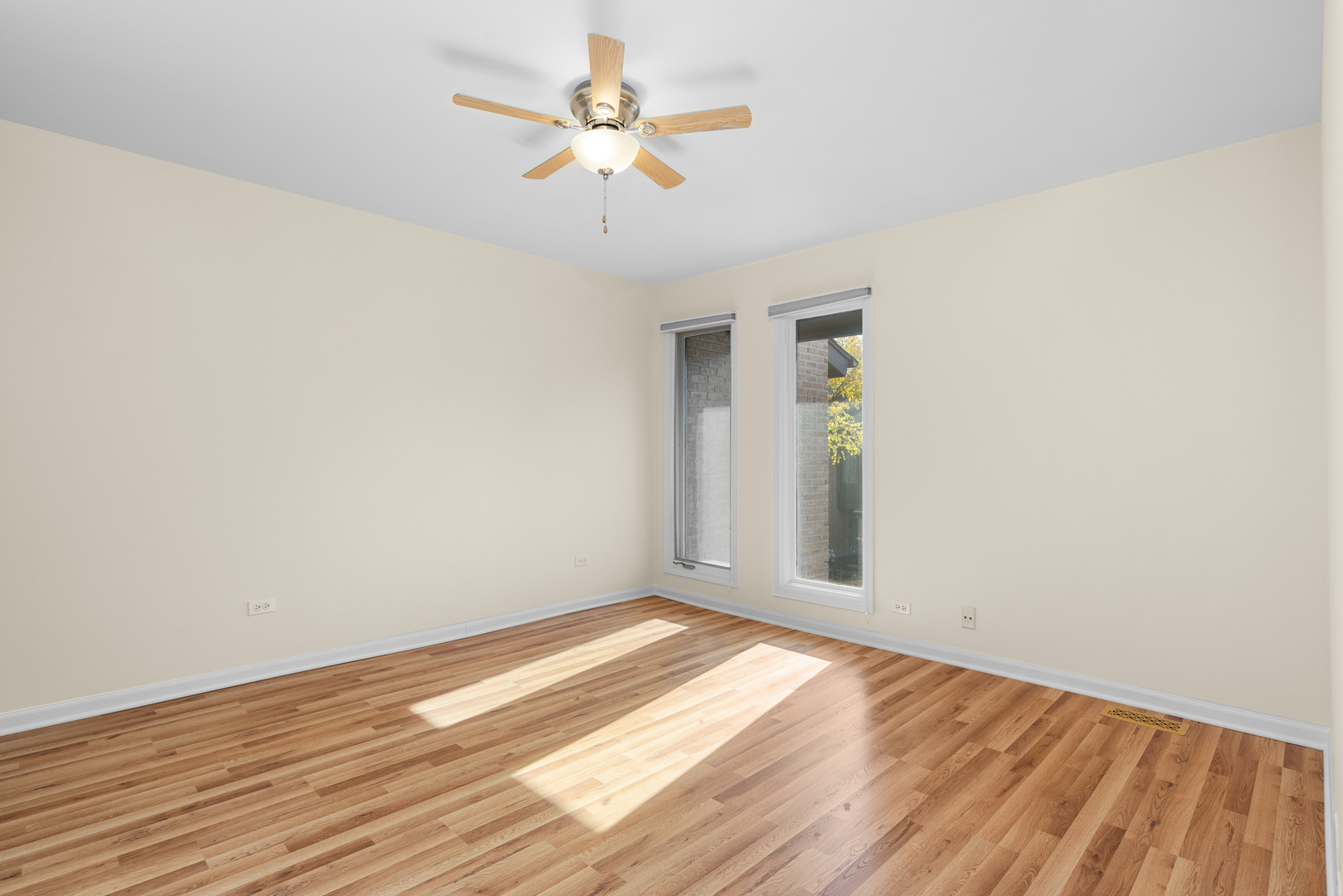 1723 Wildberry Drive, Unit C Glenview, IL 60025 - Photo 11 of 34 an empty room with wooden floor and windows