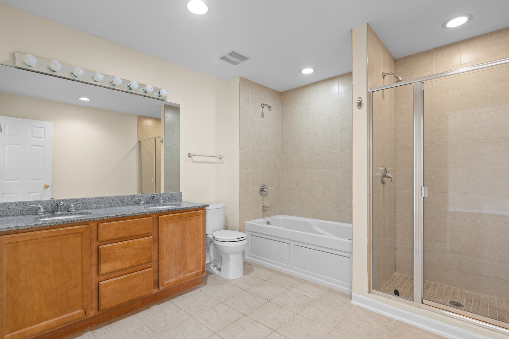 1723 Wildberry Drive, Unit C Glenview, IL 60025 - Photo 15 of 34 a bathroom with a granite countertop sink a toilet and shower