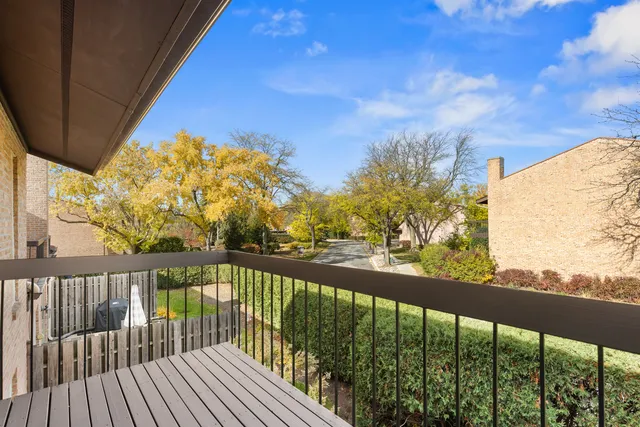 a view of a balcony with wooden fence