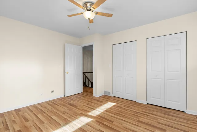 a view of a livingroom with wooden floor and a ceiling fan