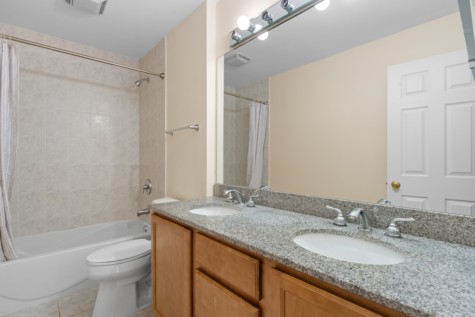 1723 Wildberry Drive, Unit C Glenview, IL 60025 - Photo 22 of 34 a bathroom with a granite countertop sink toilet and shower