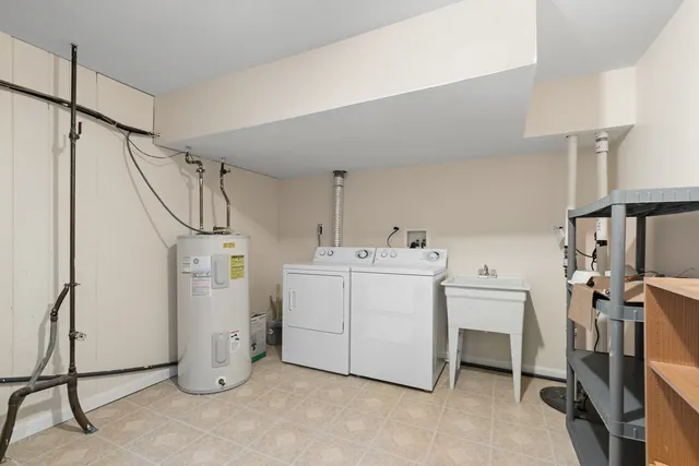 a utility room with cabinets dryer and washer
