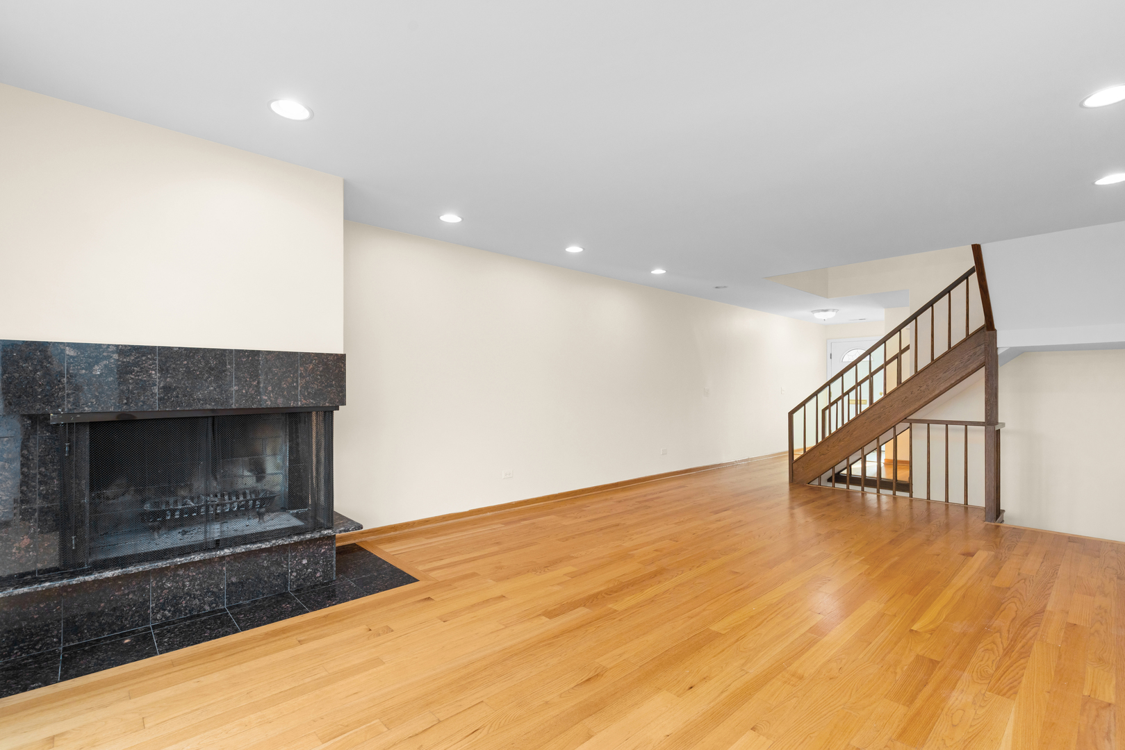1723 Wildberry Drive, Unit C Glenview, IL 60025 - Photo 4 of 34 a view of an empty room with wooden floor fireplace and a window