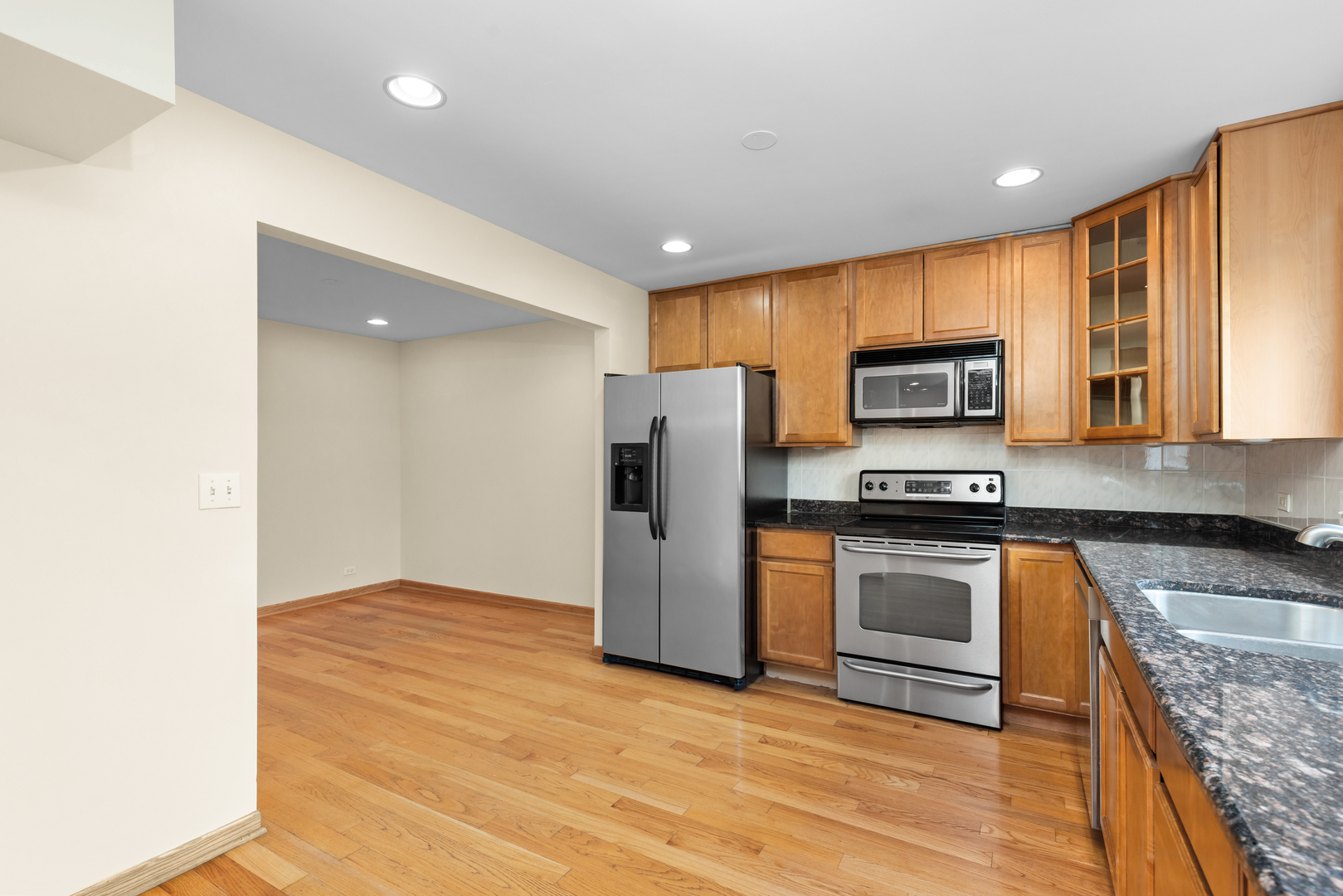 1723 Wildberry Drive, Unit C Glenview, IL 60025 - Photo 8 of 34 a kitchen with stainless steel appliances granite countertop a refrigerator microwave and sink