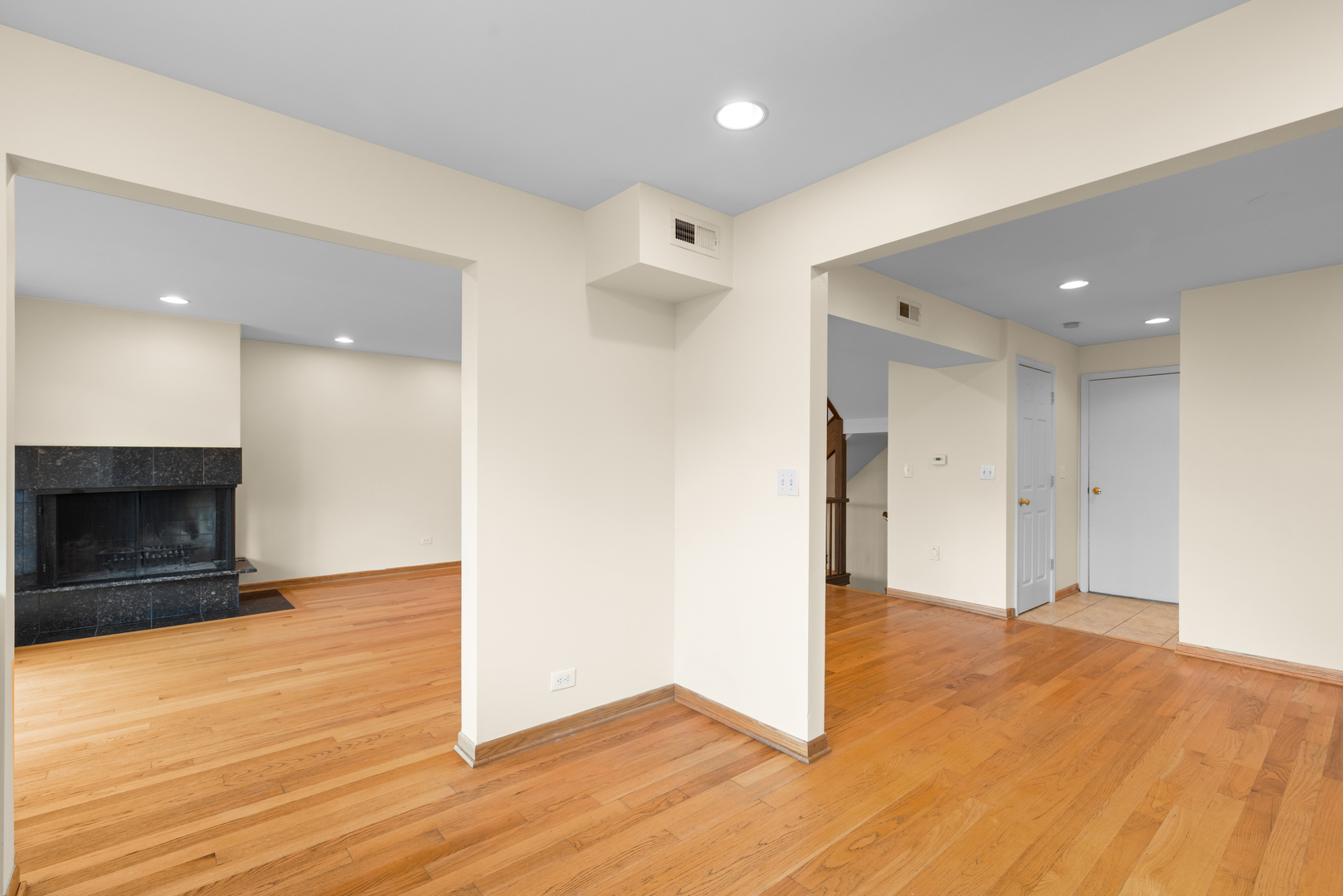 1723 Wildberry Drive, Unit C Glenview, IL 60025 - Photo 9 of 34 a view of an empty room with wooden floor and a fireplace