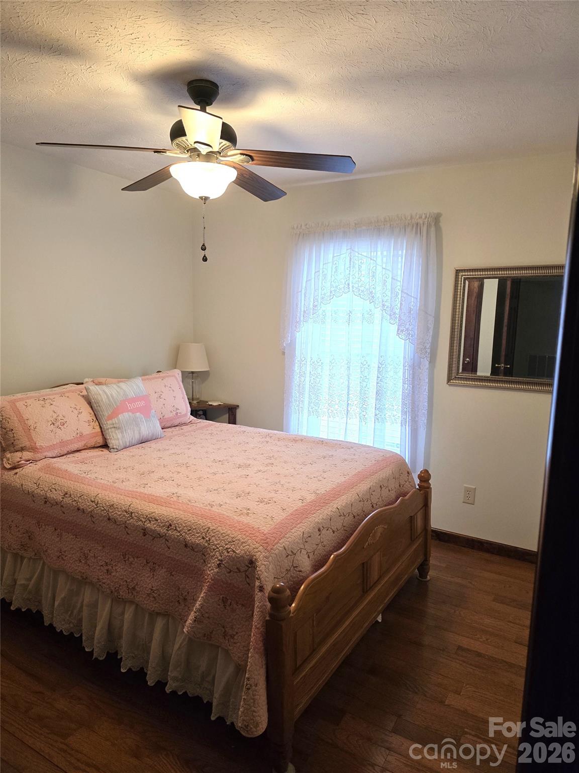476 Jackson Loop Road Flat Rock, NC 28731 - Photo 14 of 37 a bedroom with a bed and wooden floor