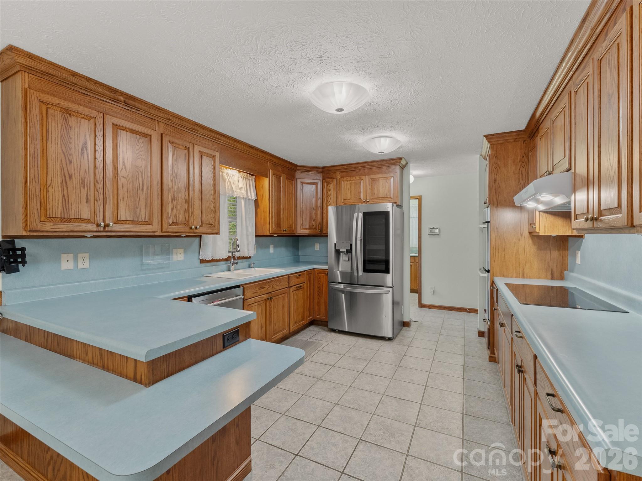 476 Jackson Loop Road Flat Rock, NC 28731 - Photo 4 of 34 a kitchen with stainless steel appliances granite countertop a sink refrigerator and cabinets