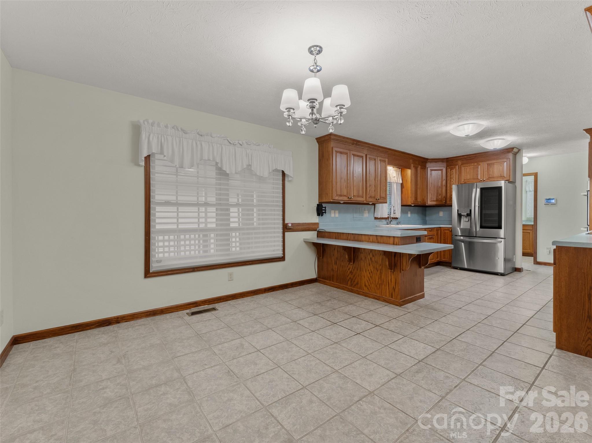 476 Jackson Loop Road Flat Rock, NC 28731 - Photo 7 of 34 a large kitchen with cabinets and stainless steel appliances