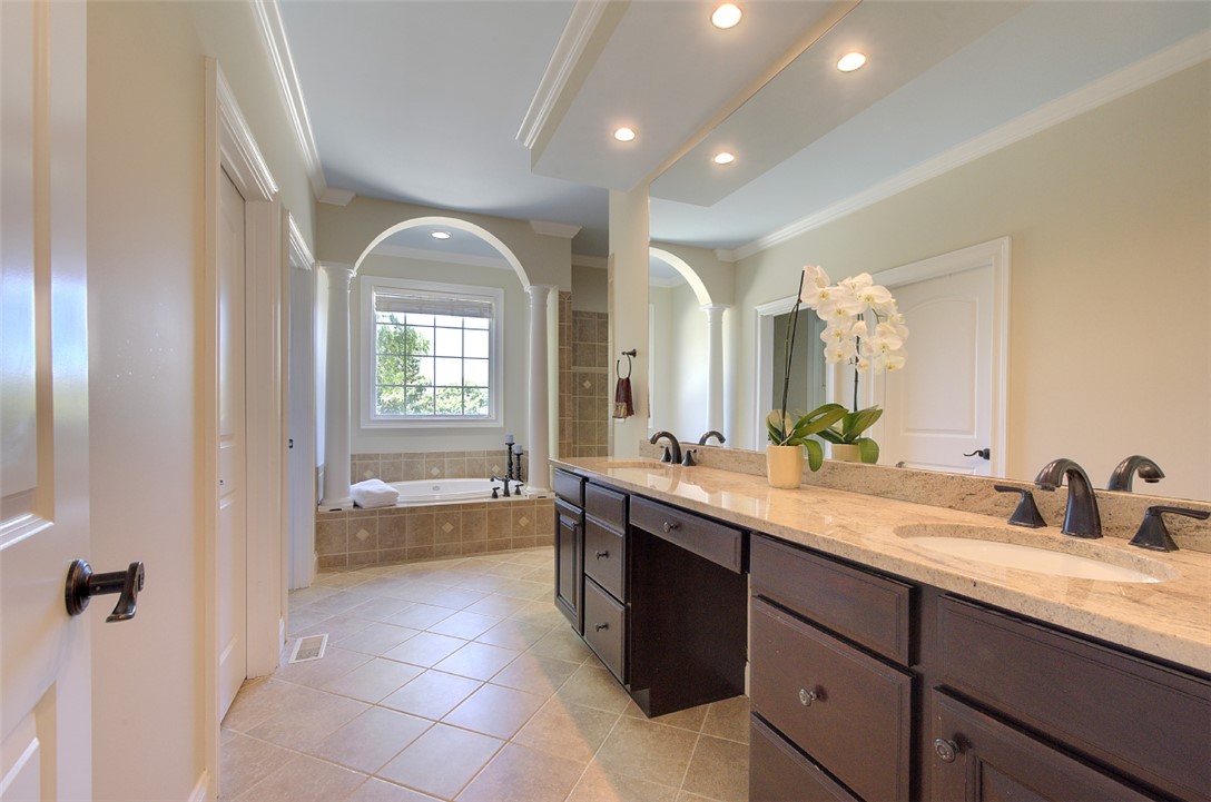 100 Turnberry Road Anderson, SC 29621 - Photo 18 of 41 Luxurious ensuite features dual vanities with granite counters and a separate soaking tub.