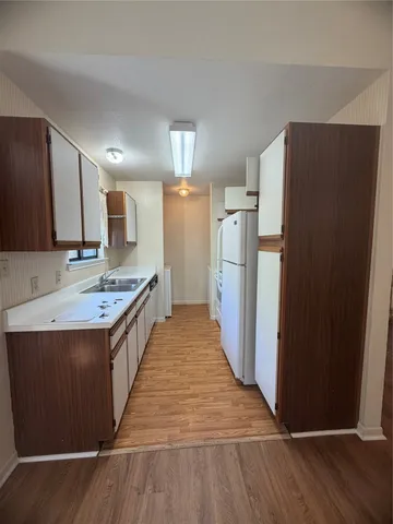a kitchen with stainless steel appliances granite countertop a refrigerator and a stove