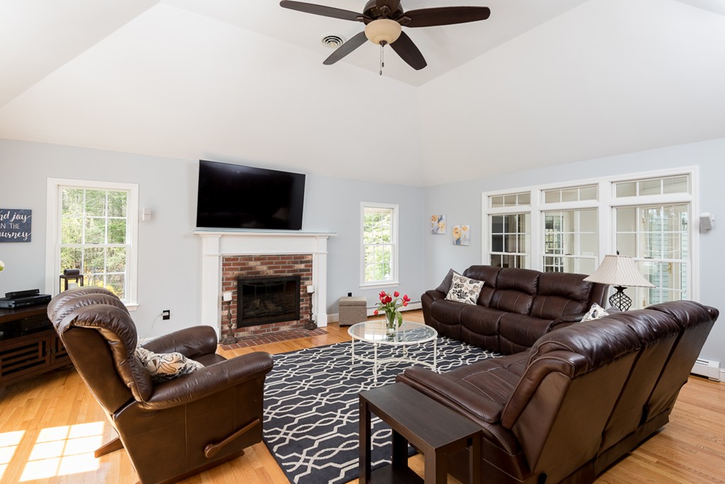 182 River Road Hanover, MA 02339 - Photo 14 of 29 a living room with furniture a fireplace and a flat screen tv