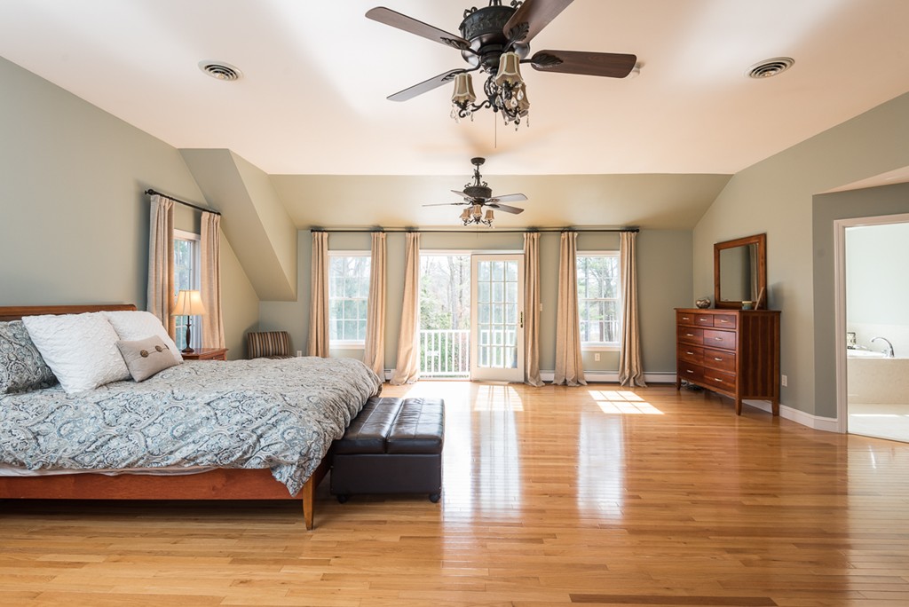 182 River Road Hanover, MA 02339 - Photo 20 of 29 a spacious bedroom with a large bed a chandelier and a window