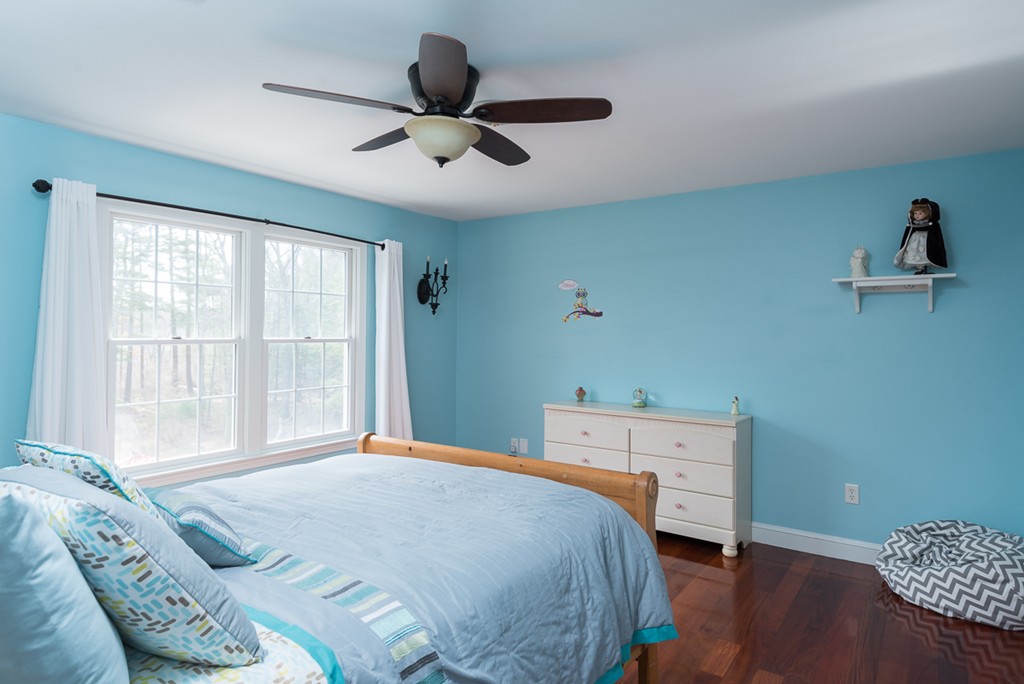 182 River Road Hanover, MA 02339 - Photo 22 of 29 a bedroom with a bed and a chandelier