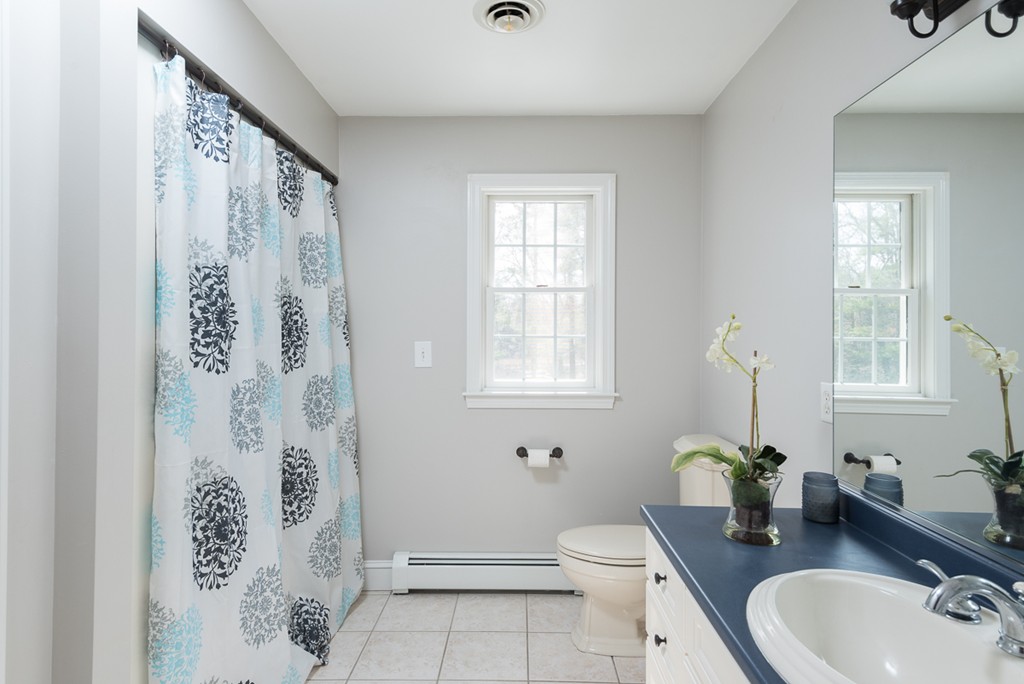 182 River Road Hanover, MA 02339 - Photo 23 of 29 a bathroom with a granite countertop sink toilet and mirror