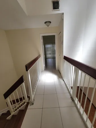 a view of a room with an empty space and a ceiling fan