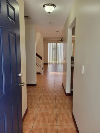 a kitchen with stainless steel appliances kitchen island granite countertop a refrigerator and a stove top oven