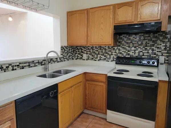 a bathroom with a granite countertop toilet sink and mirror