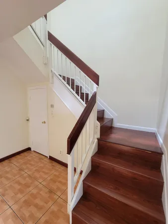 an empty room with a ceiling fan and window