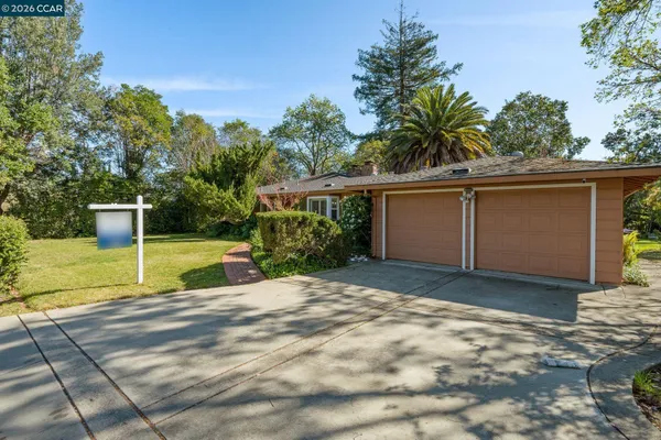 a view of a house with backyard and sitting area