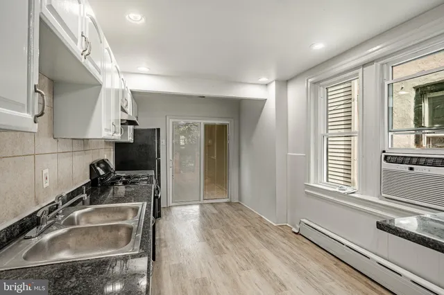 a kitchen with white cabinets and a stove