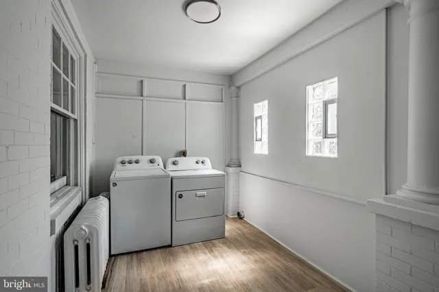 an empty room with closet and windows