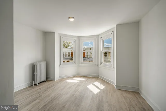 a view of an empty room and wooden floor