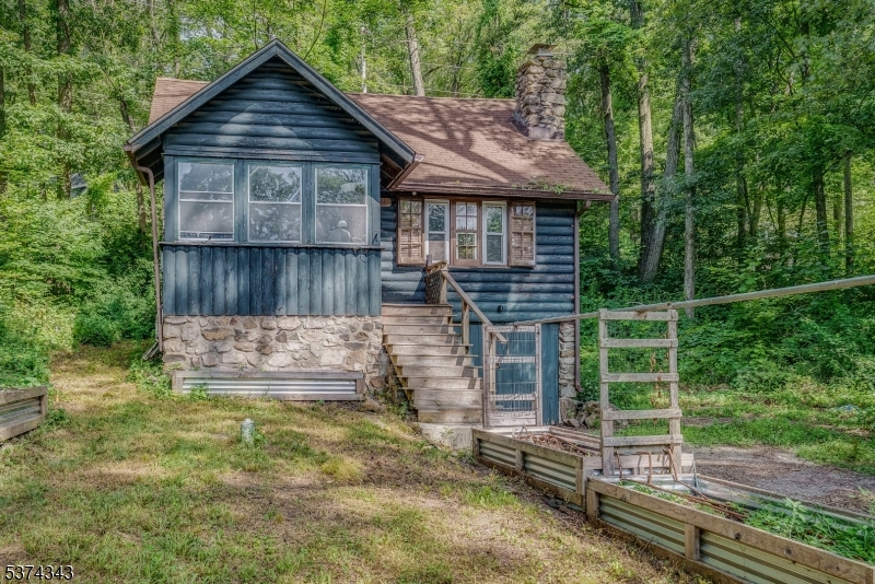 a view of a small house with a yard